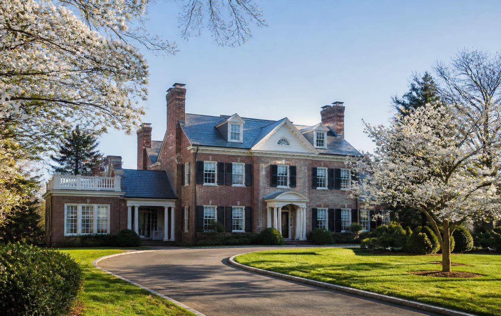 Georgian red-brick manor home with circular drive in 28277