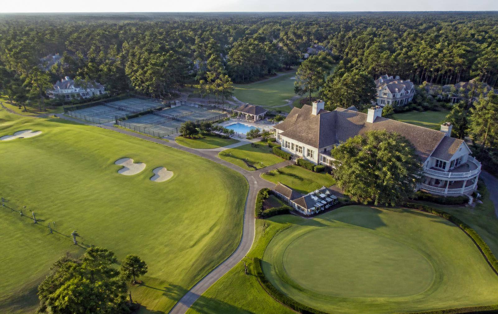 Aerial view of a Charlotte country club campus with clubhouse, courts, and fairways