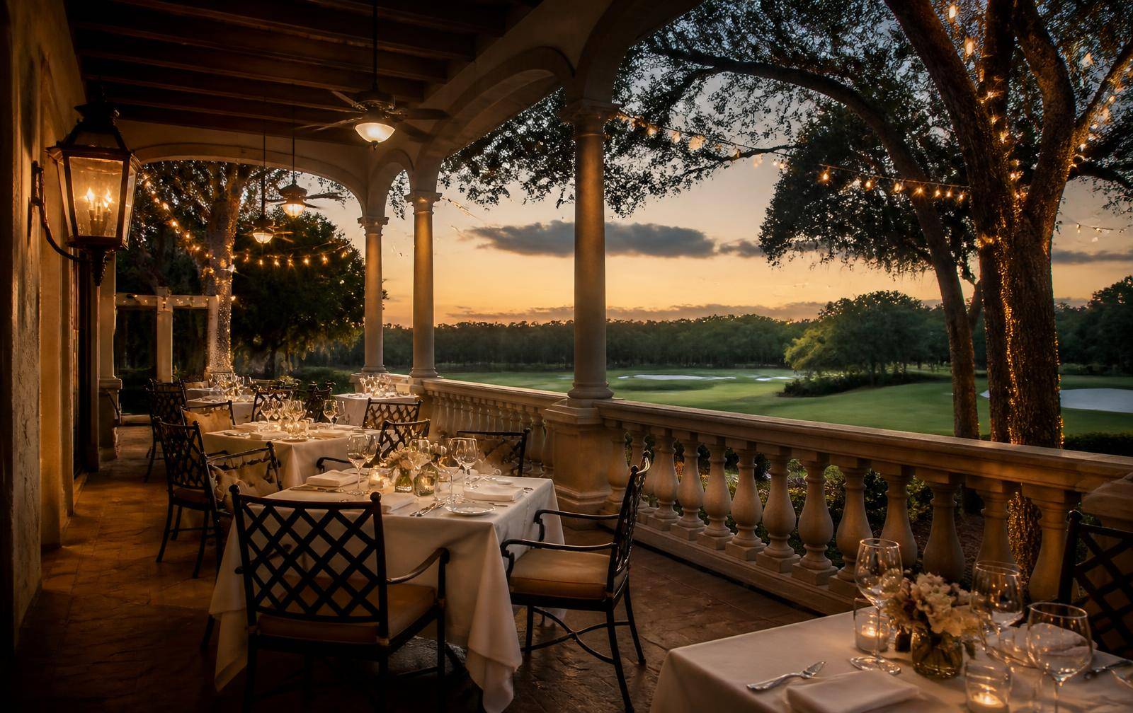 Candlelit club dining terrace overlooking the fairway at dusk