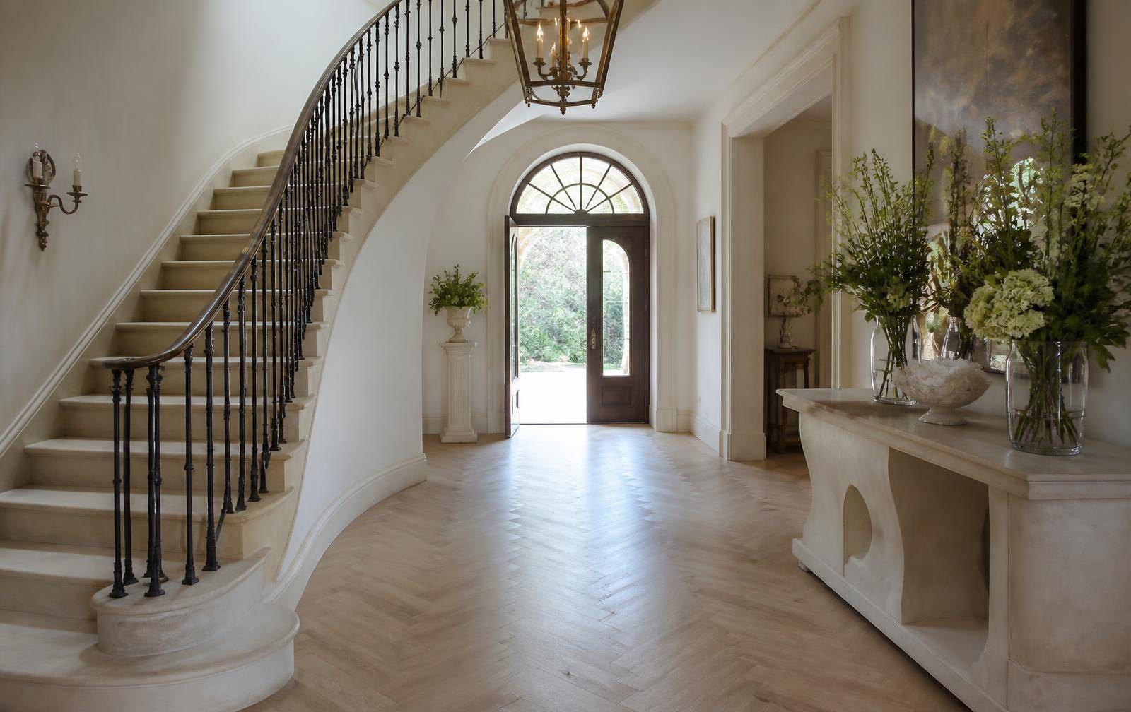 Grand entry foyer with curved staircase in a Ballantyne estate home