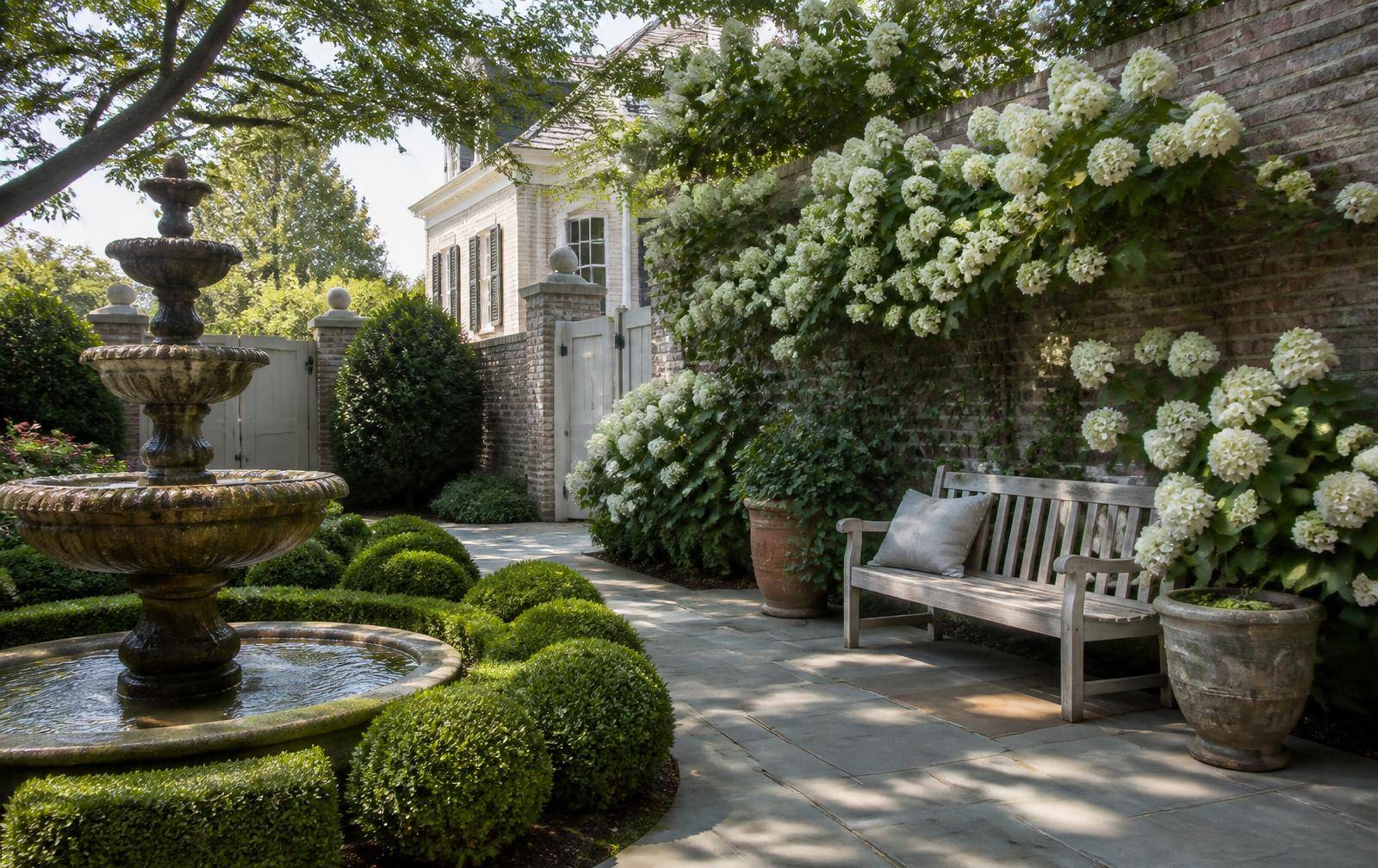 Walled garden courtyard with fountain at a Ballantyne estate home