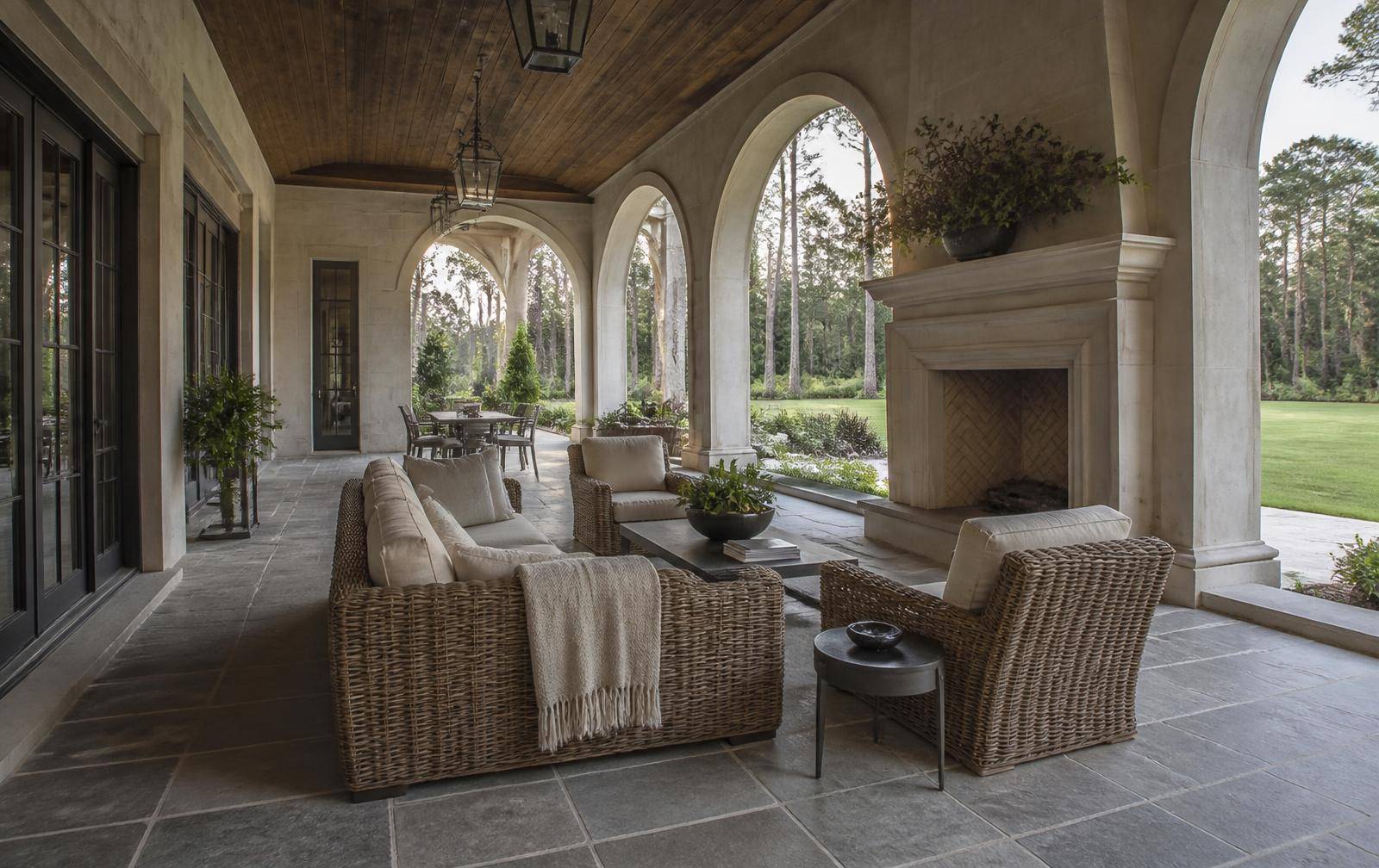 Stone loggia with limestone fireplace at a Ballantyne estate home